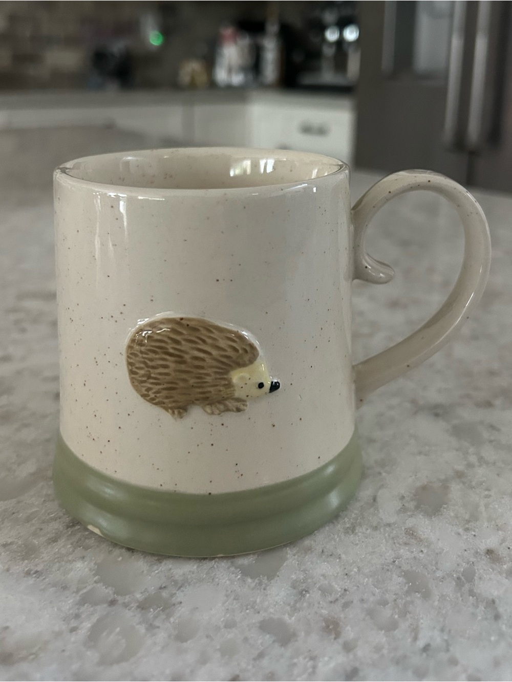 “New” Speckled Cream Ceramic Mug with Hedgehog Accent and Green Base